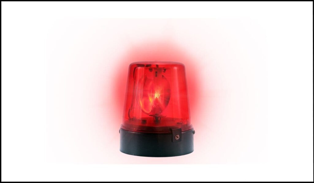 Luz de emergencia roja parpadeante, representando el problema de accesibilidad del texto parpadeante sin control en CSS.